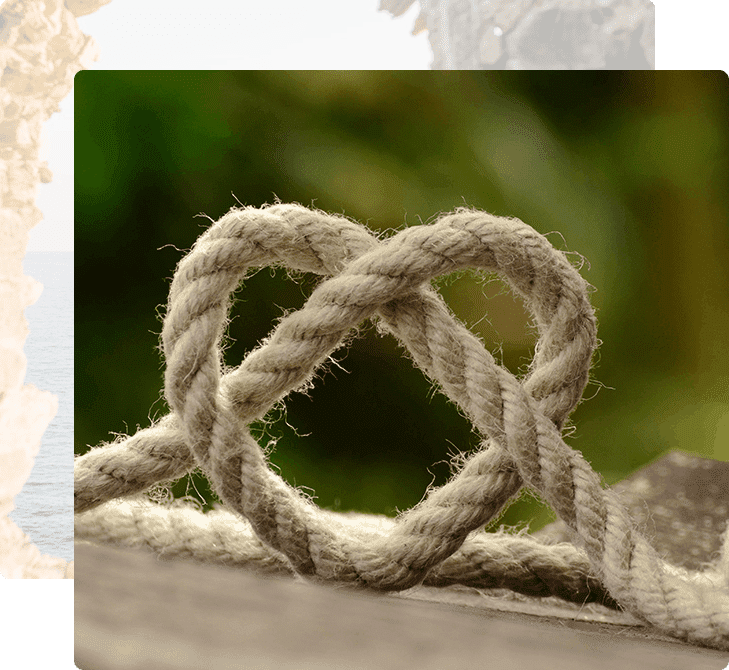 A rope knot is shown on the end of a boat.